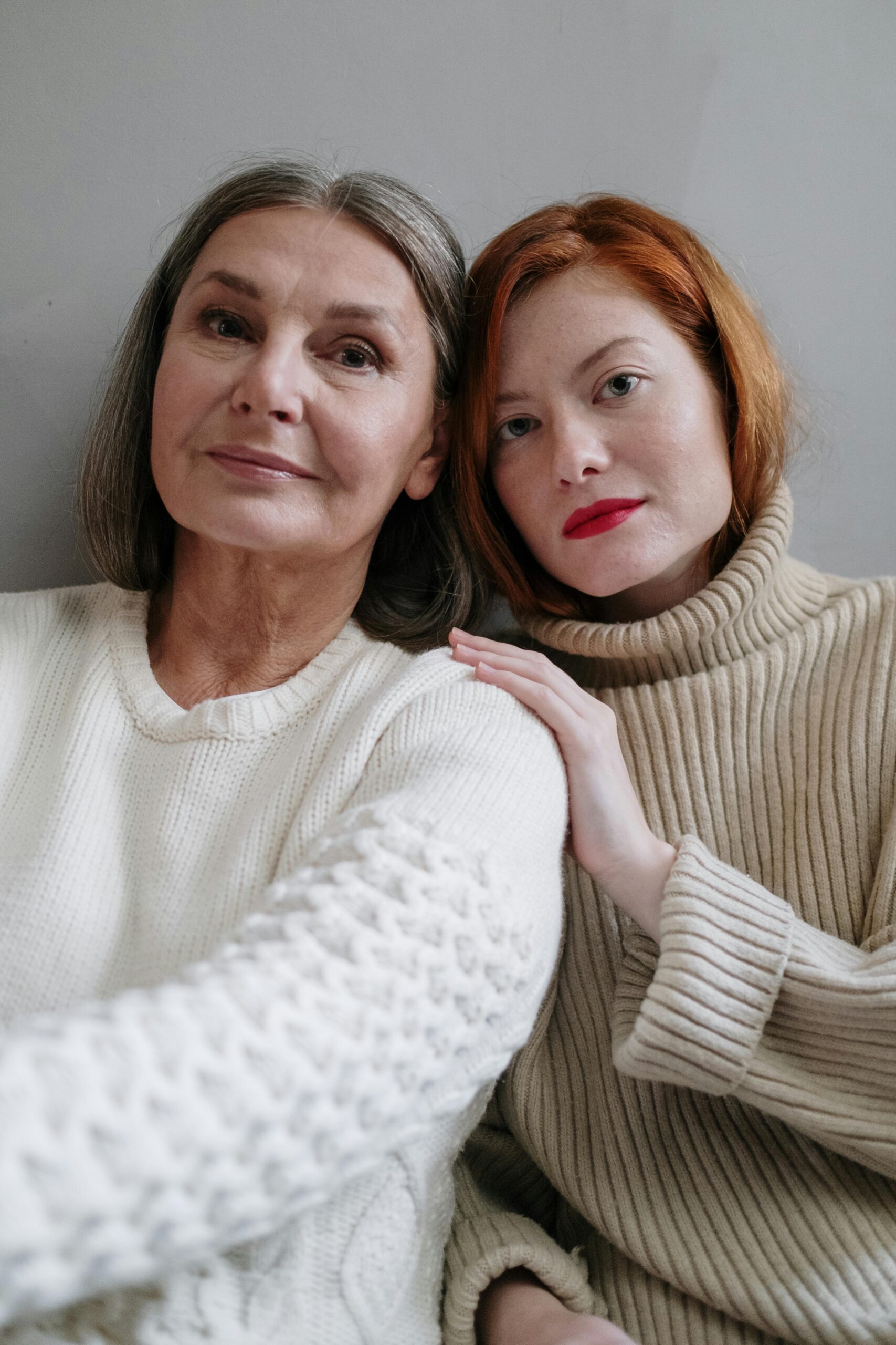 Loving daughter putting a reassuring hand on mother's shoulder
