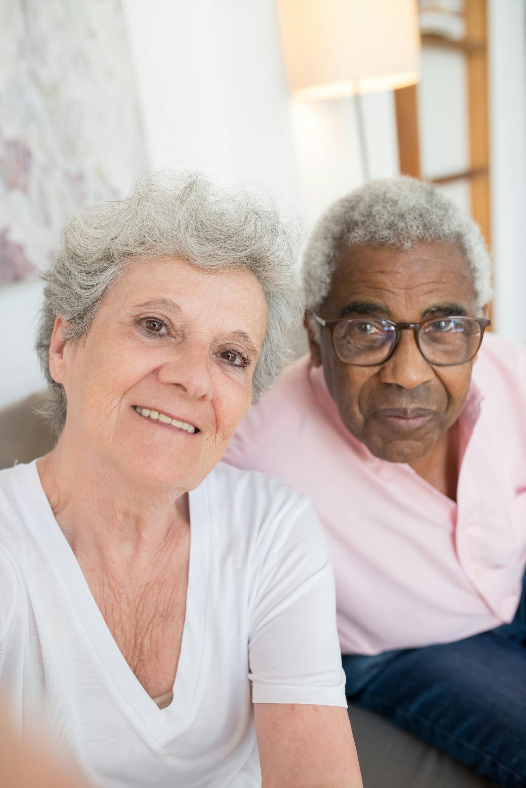 Joyful senior couple enjoying a comfortable day indoors, capturing a happy moment together.